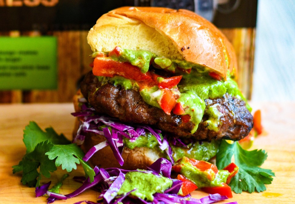 CHARD Burger Press Elk Burger with Spicy Green Tahini Sauce Red Pepper Relish